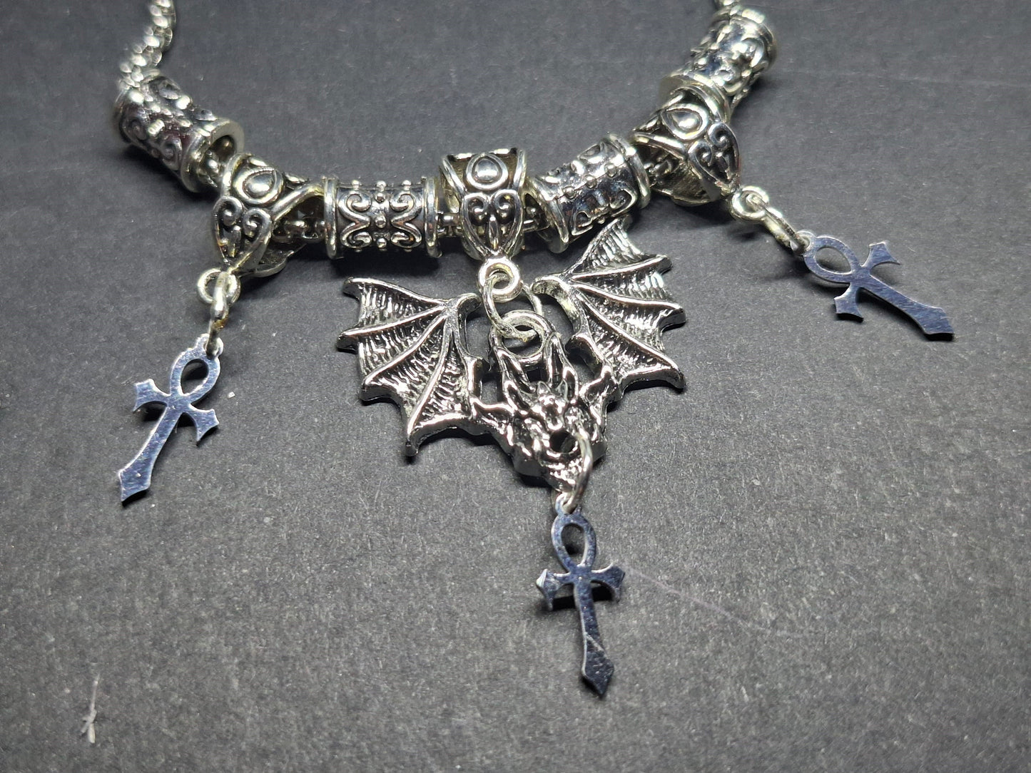 Metal Necklace with bat charm and "Vampire Masquerade ankhs"