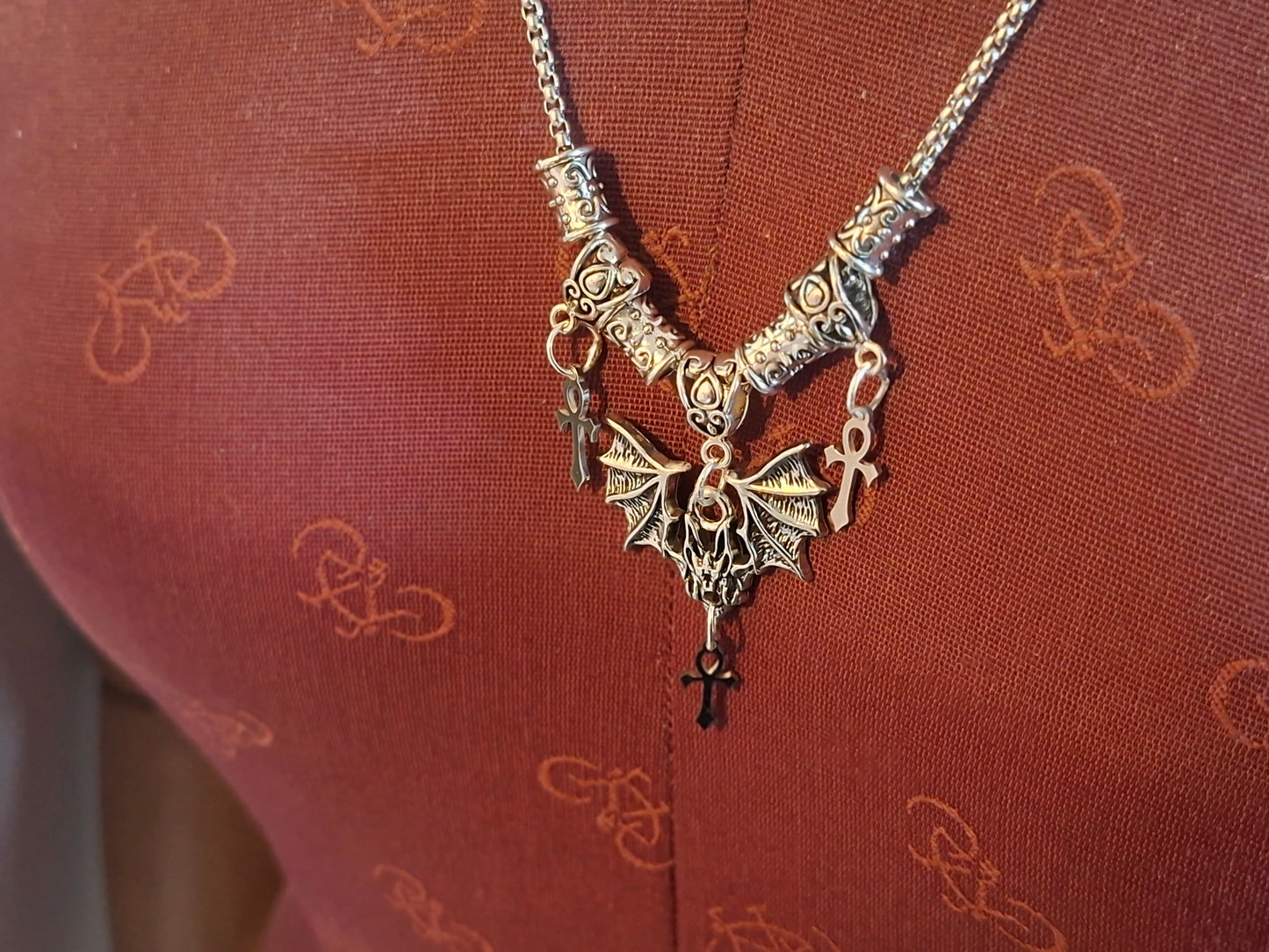 Metal Necklace with bat charm and "Vampire Masquerade ankhs"